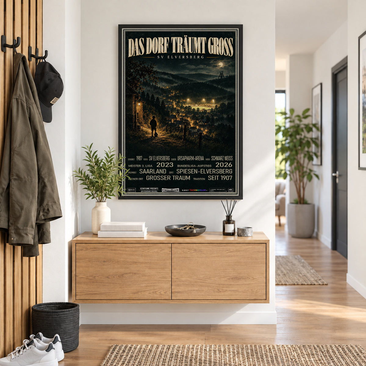 SV Elversberg Poster „Das Dorf träumt groß“ im schwarzen Rahmen über einer Holzkommode